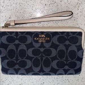 Coach Denim wristlet with leather trim.